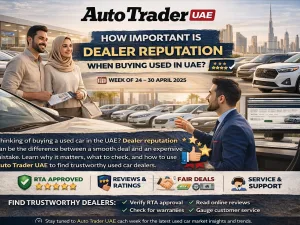 Used cars lined up in a Dubai dealership parking area at sunset