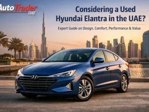 Side view of a used Hyundai Elantra driving on a UAE city road