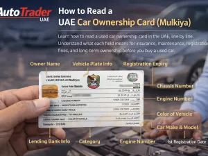 Sample UAE car ownership card (Mulkiya) being checked during used car purchase