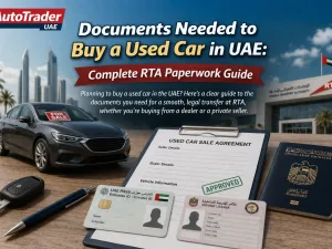 Customer submitting documents to transfer ownership of a used car in the UAE at an RTA service center