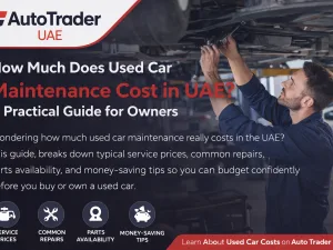 Mechanic performing routine maintenance on a used car in a UAE workshop