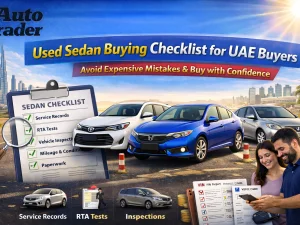 Used sedan parked in UAE with buyer inspecting the exterior before purchase
