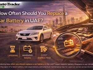 Mechanic testing a car battery in a UAE workshop