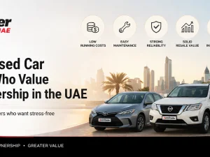 Used cars parked in a UAE dealership lot under the sun