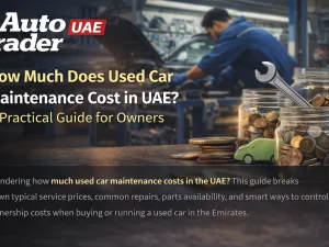 Mechanic performing routine maintenance on a used car in a UAE workshop
