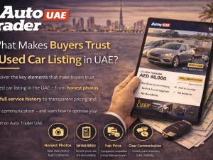 Buyer inspecting a trustworthy used car listing in the UAE on a laptop and smartphone