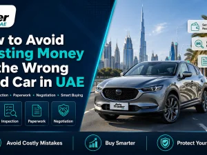 Used cars parked in a UAE showroom with a buyer inspecting a vehicle