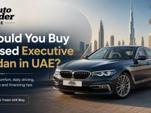 Used executive sedan driving on a UAE highway at sunset