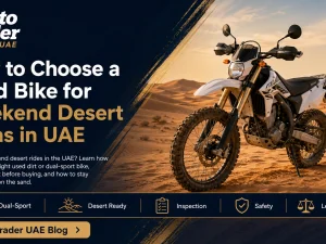 Used dirt bike parked on UAE desert sand at sunset