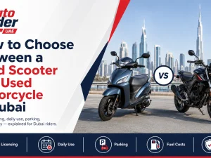 Used scooter and motorcycle parked side by side on a Dubai street at sunset