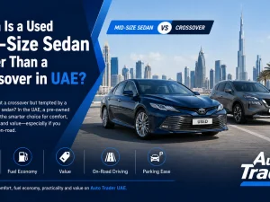 Used mid-size sedan driving on a UAE highway at sunset