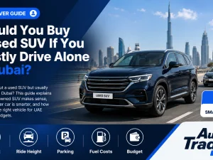 Used SUV driving on a Dubai highway with city skyline in the background