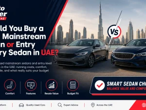Used mainstream sedan and entry luxury sedan parked side by side in UAE
