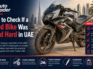 Used sport bike parked outdoors in the UAE being inspected for signs of hard use