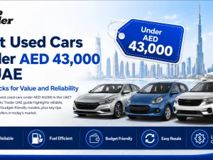 Line-up of affordable used cars parked in a UAE city under bright daylight