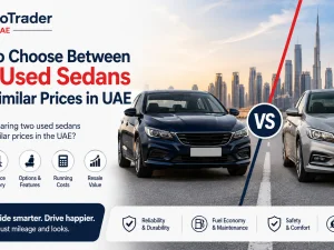 Two used sedans parked side by side in UAE, being compared by a buyer