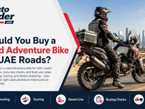 Used adventure bike parked on a UAE highway overlooking desert landscape