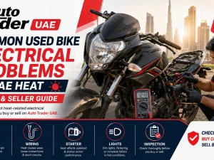 Used motorcycle parked outdoors in UAE heat with focus on battery and wiring
