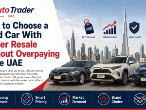 Used cars parked in a Dubai parking lot with city skyline, representing choosing a used car with strong resale value